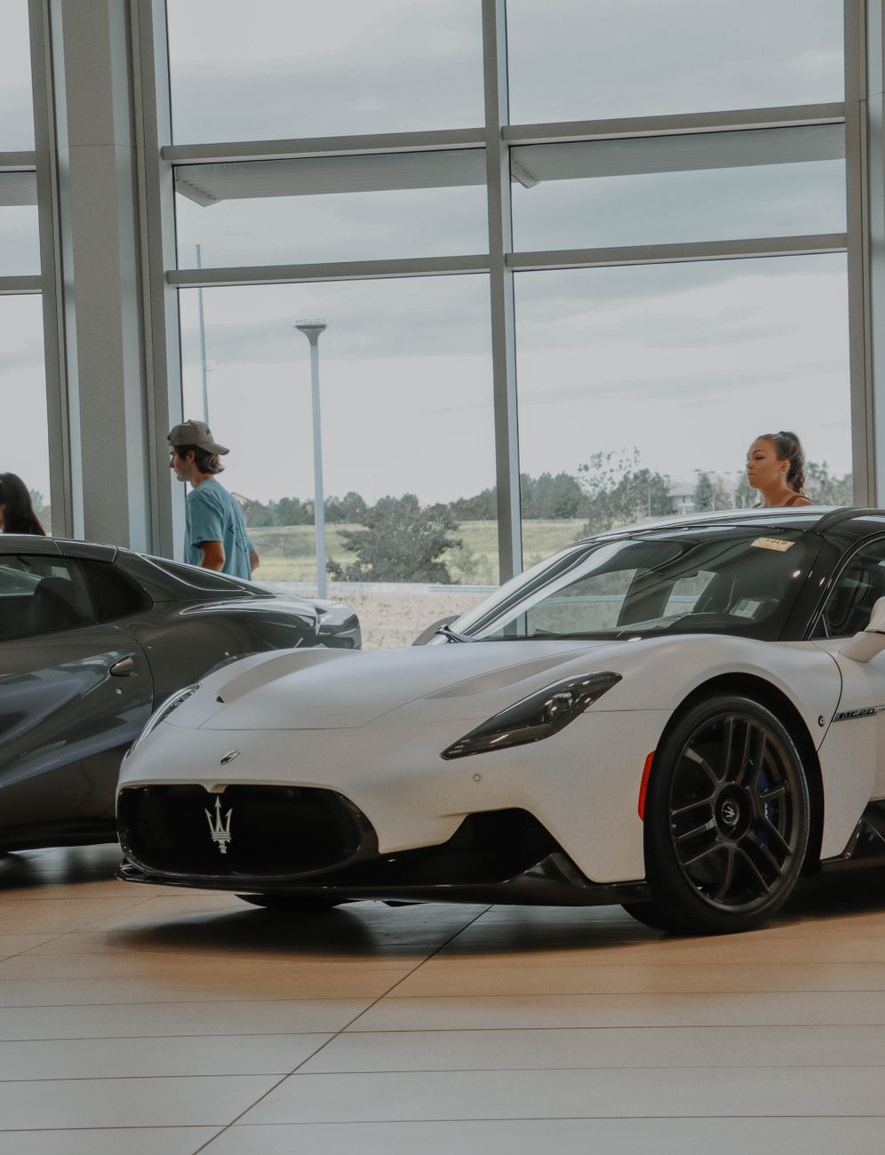 New cars on display in a bright car dealership showroom
