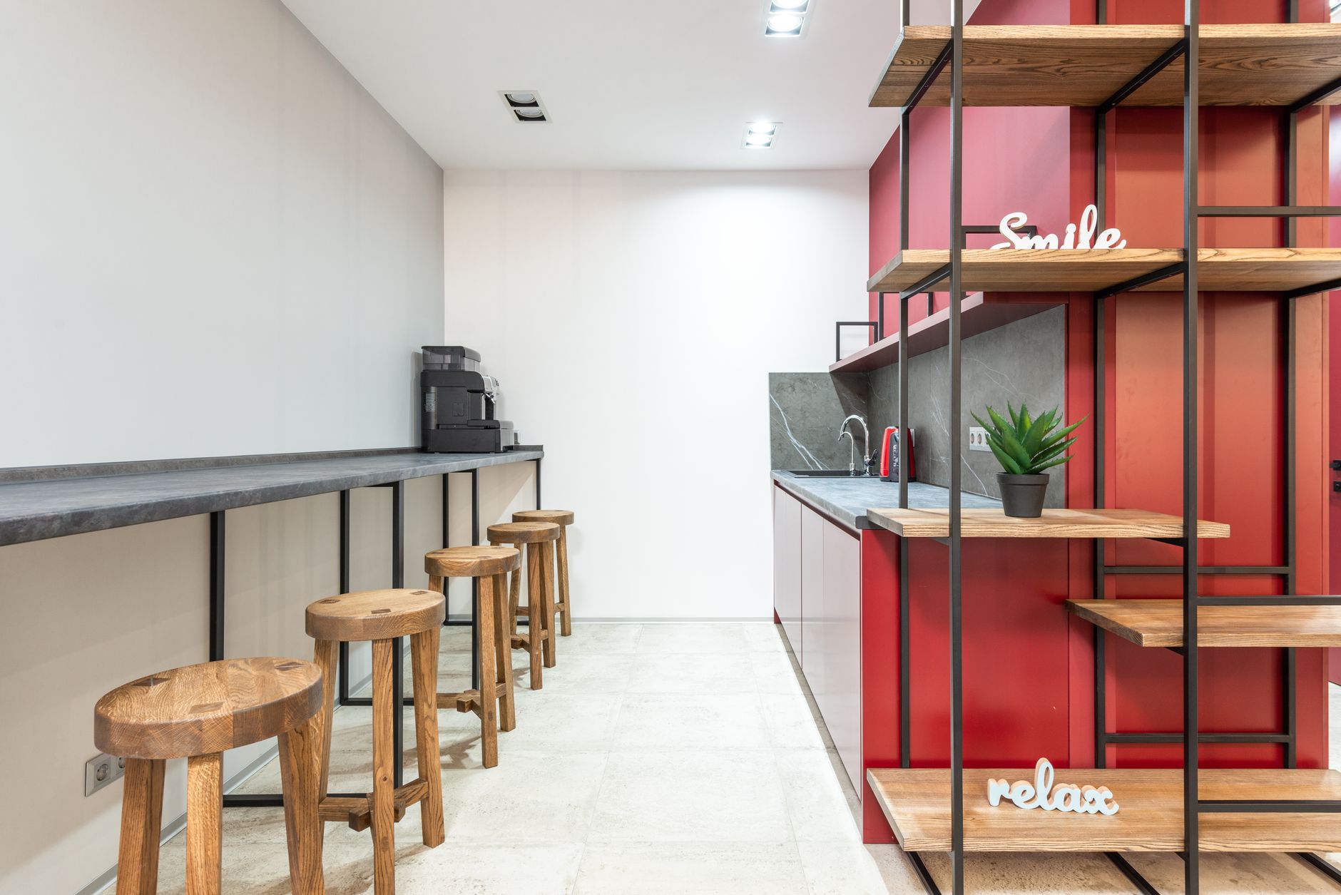 Modern office breakroom with counter seating, a clean professional setting for a vending machine placement